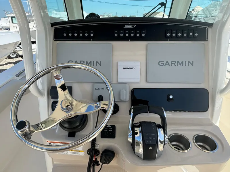 Slide: The Image of 2021 Boston Whaler 250 Outrage helm with Garmin displays and Mercury controls. - 15