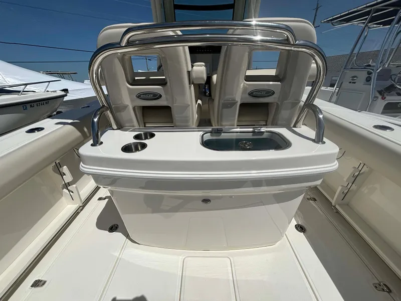 Slide: The Image of 2021 Boston Whaler 250 Outrage boat interior with seating and sink, showcasing luxury features. - 17