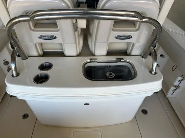 Slide: The Image of 2021 Boston Whaler 250 Outrage boat console with sink and cup holders. - 18