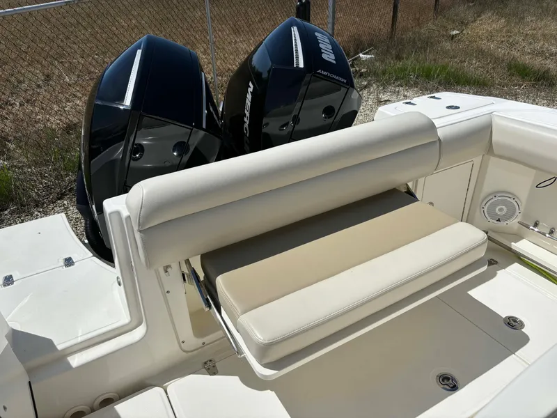 Slide: The Image of 2021 Boston Whaler 250 Outrage boat with dual engines and cushioned seating. - 19