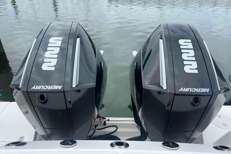 Slide: The Image of Twin Mercury outboard engines on a 2021 Boston Whaler 250 Outrage boat. - 25