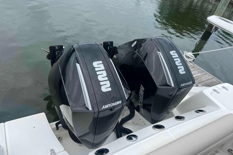 Slide: The Image of Twin Mercury outboard engines on a 2021 Boston Whaler 250 Outrage boat. - 26