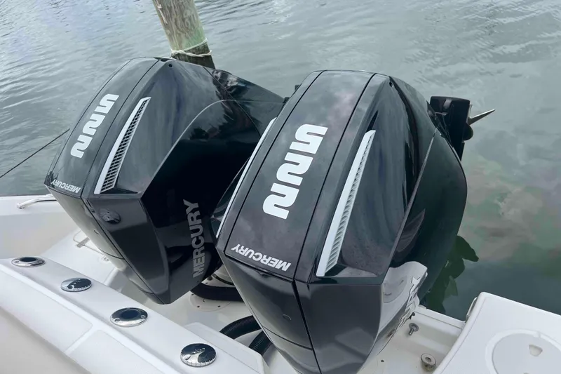 Slide: The Image of Twin Mercury outboard engines on a 2021 Boston Whaler 250 Outrage boat. - 27