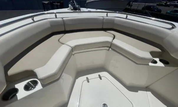 Slide: The Image of 2021 Boston Whaler 250 Outrage boat interior with cushioned seating and cup holders. - 8