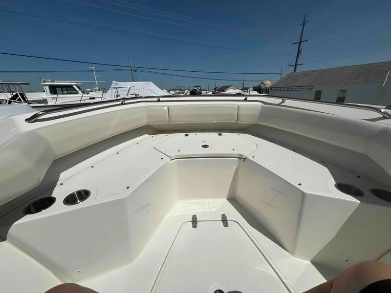 Slide: The Image of 2021 Boston Whaler 250 Outrage boat interior with spacious seating and cup holders. - 9