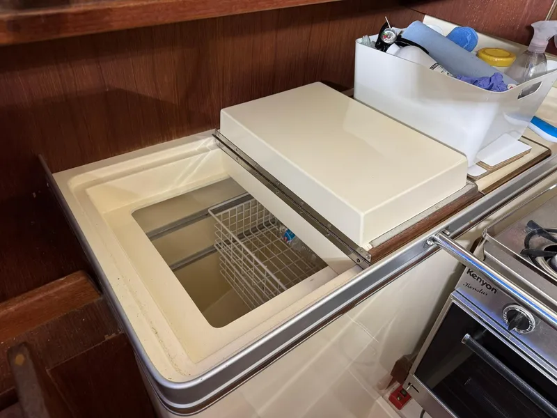 Slide: The Image of 1984 Canadian Sailcraft 36 yacht interior with built-in kitchen storage and appliances. - 13