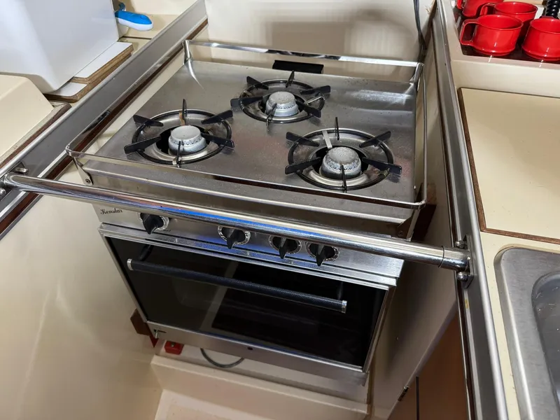 Slide: The Image of Stove and oven in 1984 Canadian Sailcraft 36 yacht kitchen, featuring three burners. - 14