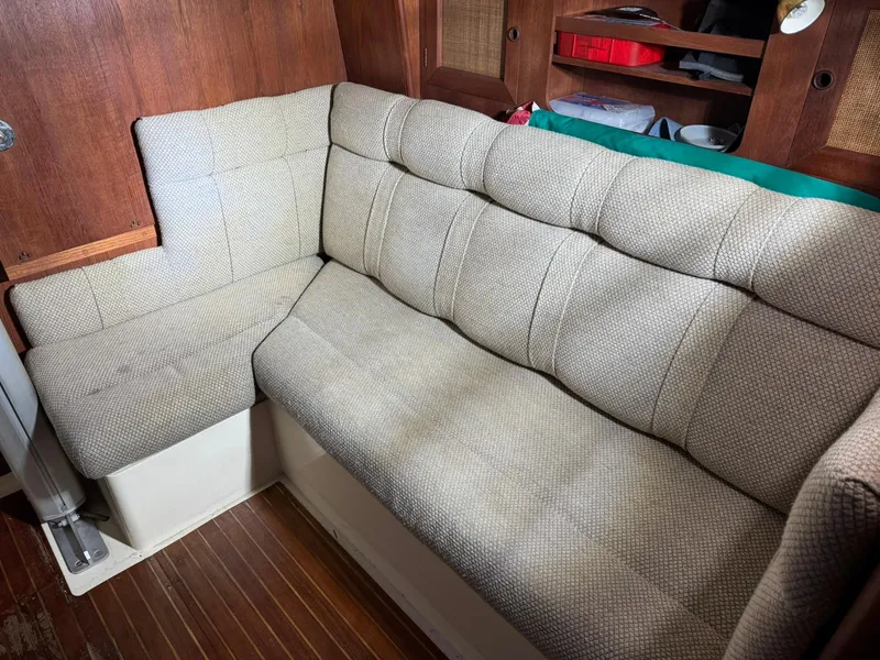 Slide: The Image of Interior of 1984 Canadian Sailcraft 36 with cushioned seating and wooden accents. - 26