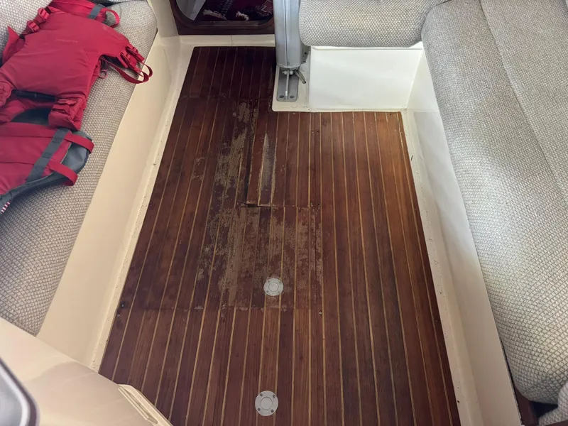 Slide: The Image of 1984 Canadian Sailcraft 36 interior with wooden flooring and seating. - 33