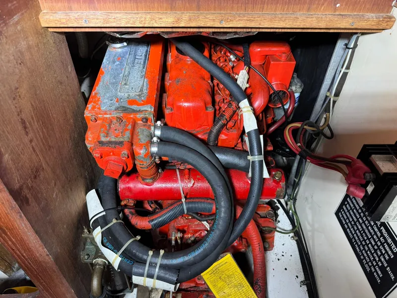 Slide: The Image of Engine compartment of a 1984 Canadian Sailcraft 36 sailboat, featuring red engine components. - 34