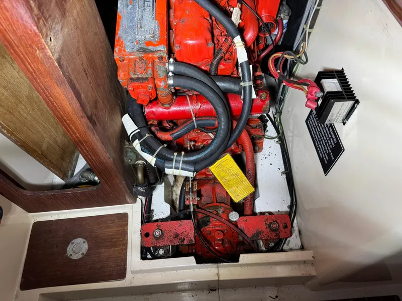 Slide: The Image of Engine compartment of a 1984 Canadian Sailcraft 36 sailboat, featuring red mechanical components. - 35