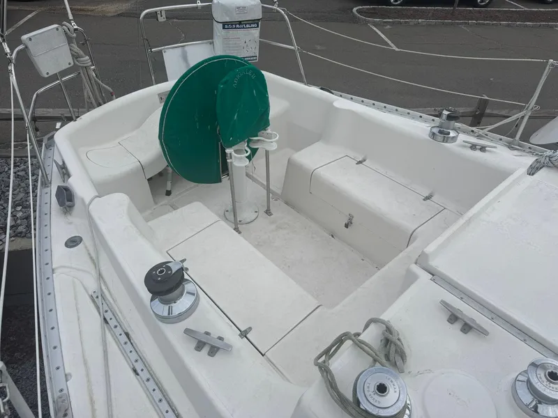 Slide: The Image of 1984 Canadian Sailcraft 36 sailboat cockpit with seating and green wheel cover. - 40