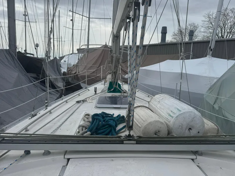 Slide: The Image of 1984 Canadian Sailcraft 36 sailboat deck with ropes and fenders, docked in a marina. - 43
