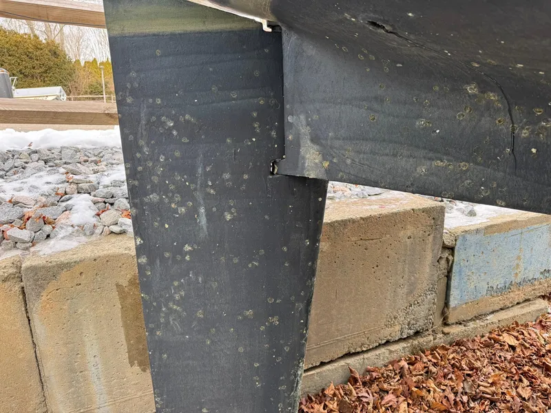 Slide: The Image of Keel of 1984 Canadian Sailcraft 36 sailboat on dry dock with visible wear. - 8