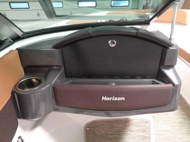 Slide: The Image of 2017 Four Winns Horizon 190 dashboard with cup holder and storage compartment. - 4