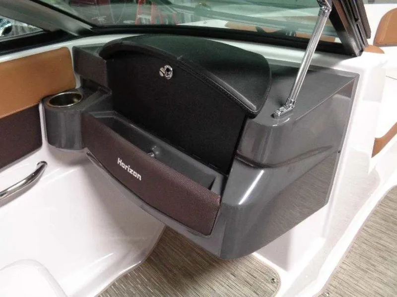 Slide: The Image of 2017 Four Winns Horizon 190 boat interior with glove compartment and cup holder. - 6