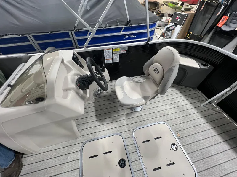 Slide: The Image of 2023 Princecraft Brio Electric 170 boat interior with steering console and seating. - 14