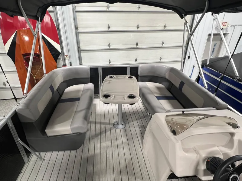 Slide: The Image of 2023 Princecraft Brio Electric 170 pontoon boat interior with seating and table. - 5