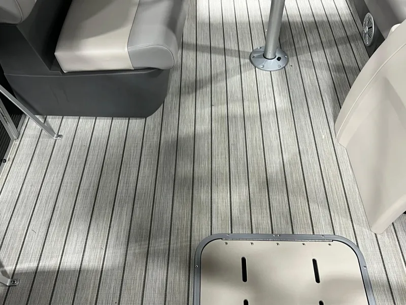 Slide: The Image of 2023 Princecraft Brio Electric 170 interior with striped flooring and cushioned seating. - 6