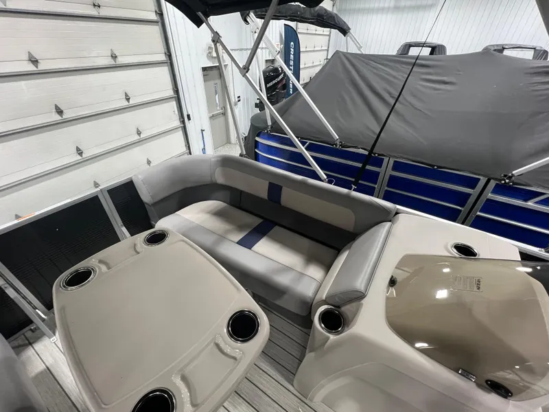 Slide: The Image of 2023 Princecraft Brio Electric 170 interior with seating and cup holders in a showroom. - 8