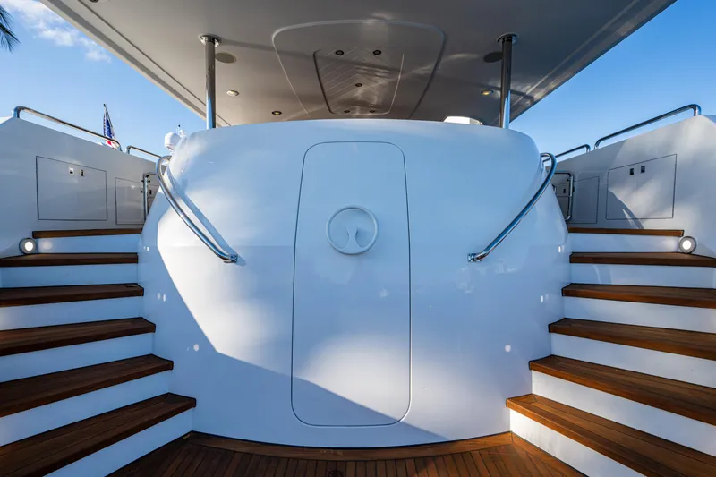 Slide: The Image of Staircase on 2002 Westport 112 yacht with sleek white design and wooden steps. - 10