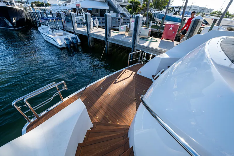 Slide: The Image of Westport 112 yacht docked at marina, wooden deck, 2002 model. - 12