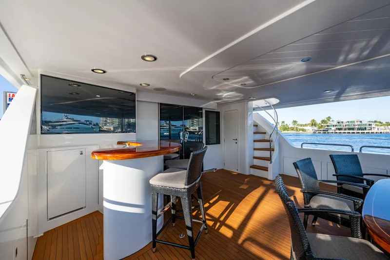 Slide: The Image of Luxurious 2002 Westport 112 yacht deck with bar, seating, and ocean view. - 13