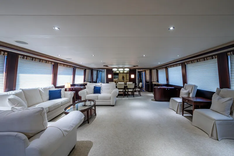 Slide: The Image of Luxurious interior of a 2002 Westport 112 yacht with elegant seating and dining area. - 17