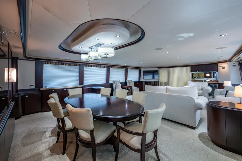 Slide: The Image of Luxurious interior of 2002 Westport 112 yacht with elegant dining and seating areas. - 23