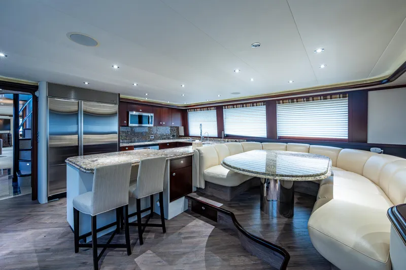 Slide: The Image of Luxurious interior of 2002 Westport 112 yacht with modern kitchen and dining area. - 24