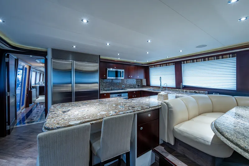 Slide: The Image of Luxurious interior of 2002 Westport 112 yacht with modern kitchen and elegant seating area. - 25