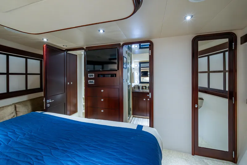 Slide: The Image of Luxurious bedroom interior of 2002 Westport 112 yacht with blue bedding and wooden accents. - 33