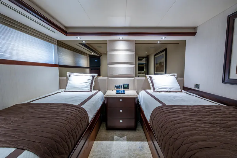 Slide: The Image of Luxurious twin bedroom in a 2002 Westport 112 yacht, featuring elegant decor and modern amenities. - 39