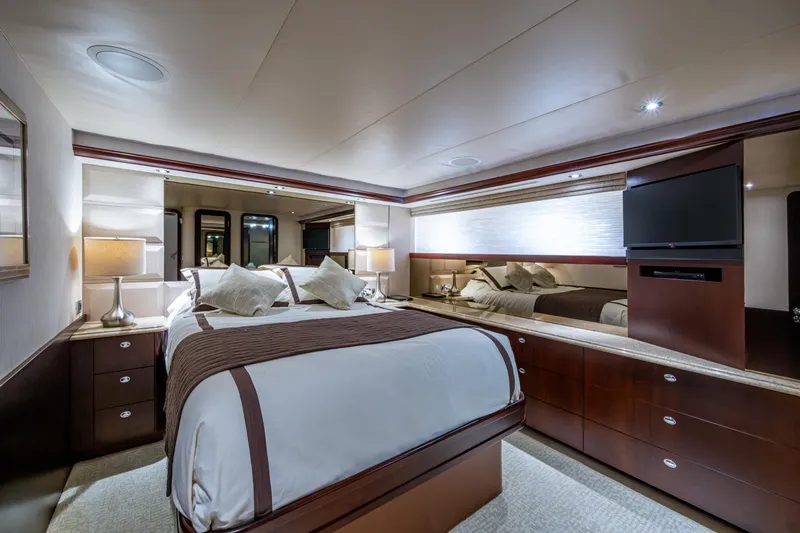 Slide: The Image of Luxurious bedroom interior on 2002 Westport 112 yacht, featuring elegant wood finishes and modern amenities. - 45