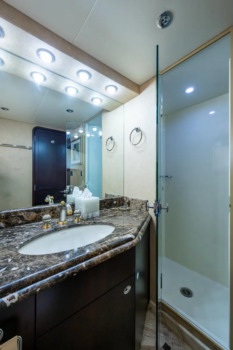 Slide: The Image of Luxurious bathroom in 2002 Westport 112 yacht with marble countertop and glass shower. - 47
