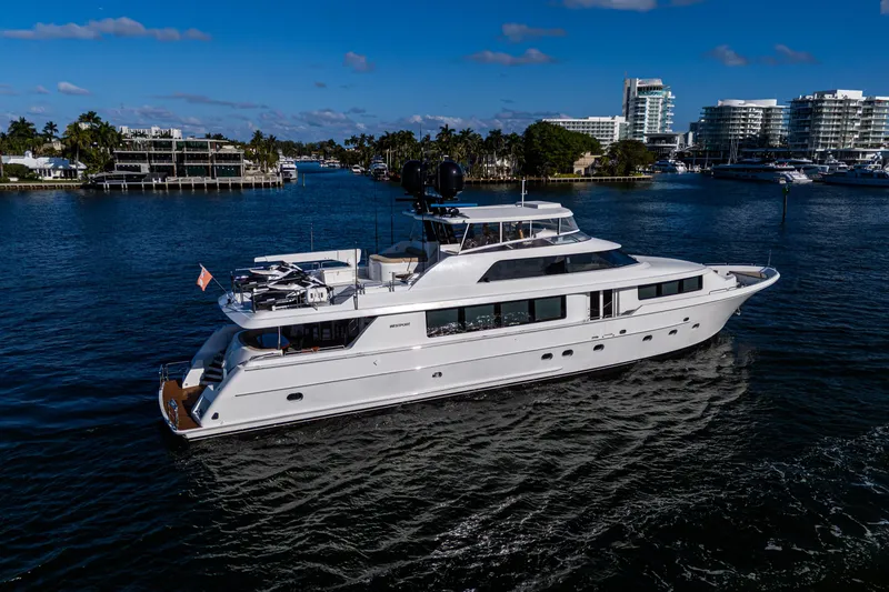 Slide: The Image of Luxurious 2002 Westport 112 yacht cruising in a scenic waterfront setting. - 8
