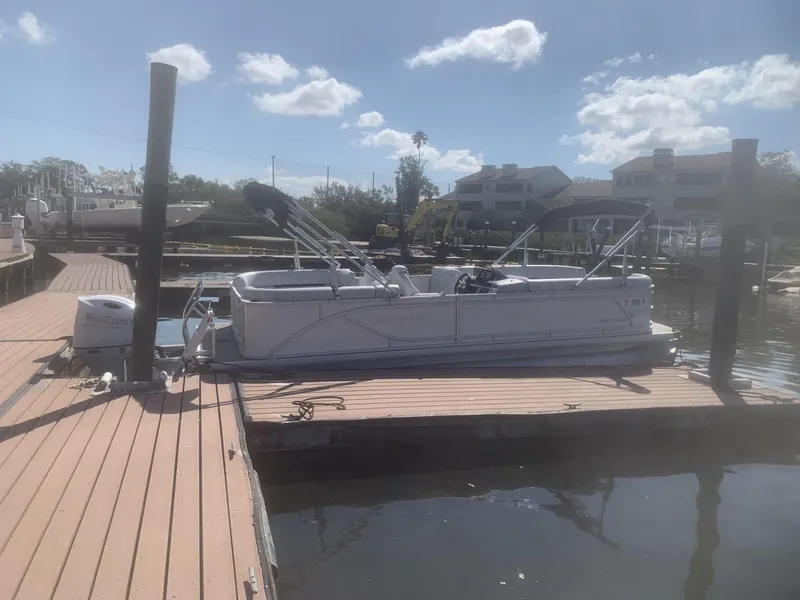 Slide: The Image of 2024 Godfrey Sweet Water 2286 SB pontoon boat docked under a sunny sky. - 6