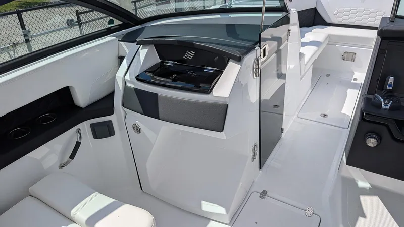 Slide: The Image of 2025 Four Winns H9 OB boat interior with sleek seating and modern design. - 13