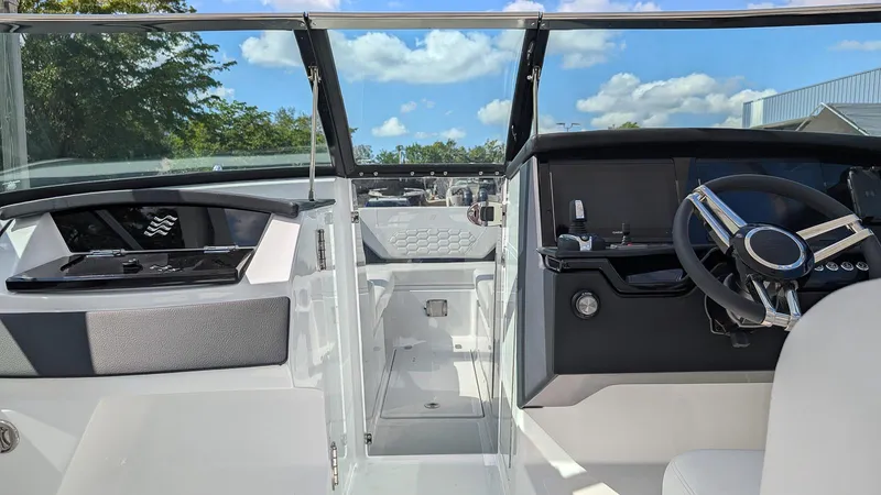 Slide: The Image of 2025 Four Winns H9 OB boat interior with modern dashboard and steering wheel. - 16