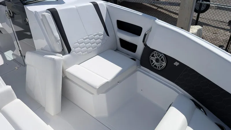 Slide: The Image of 2025 Four Winns H9 OB boat interior with white seating and speaker. - 19