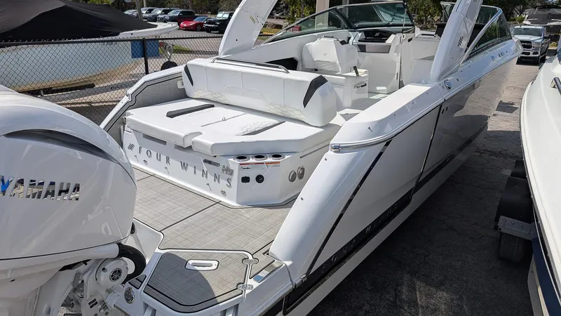 Slide: The Image of 2025 Four Winns H9 OB boat with Yamaha outboard engine, docked and ready for adventure. - 2