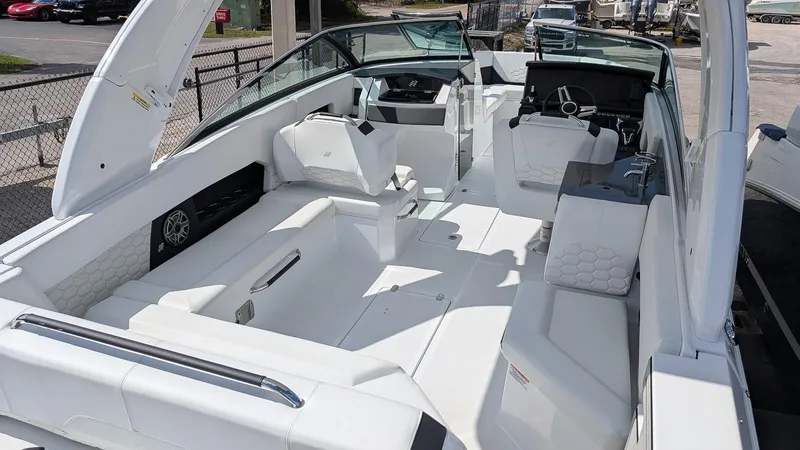 Slide: The Image of 2025 Four Winns H9 OB boat interior with white seating and modern dashboard. - 5