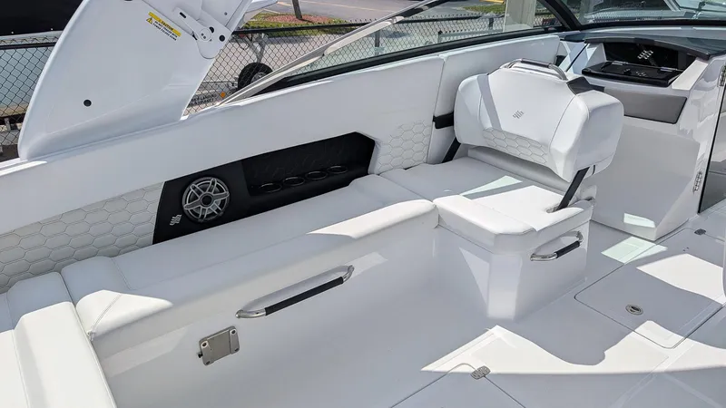 Slide: The Image of 2025 Four Winns H9 OB boat interior with white seating and modern design. - 7