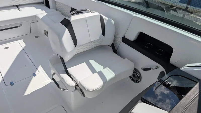 Slide: The Image of 2025 Four Winns H9 OB boat interior with white seating and cup holders. - 8