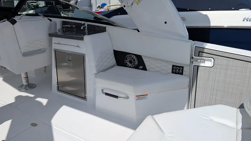 Slide: The Image of 2025 Four Winns H9 OB boat interior with white seating and modern amenities. - 9