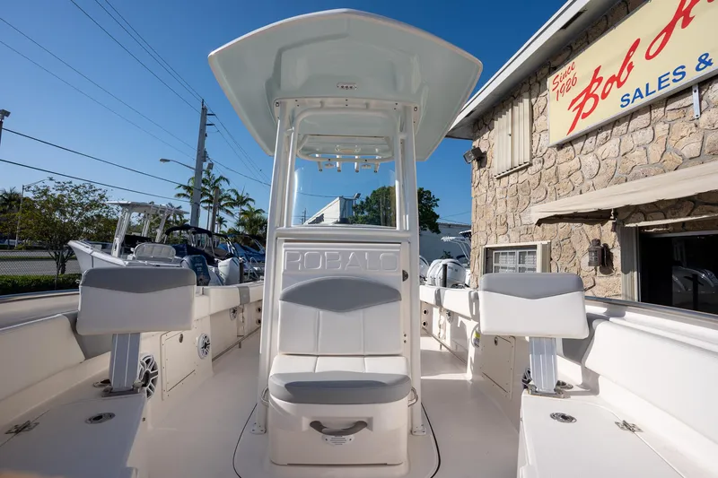 Slide: The Image of 2022 Robalo R242 boat interior with seating, under a clear blue sky. - 11