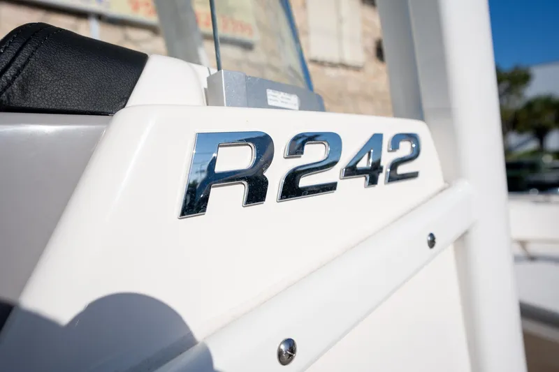 Slide: The Image of 2022 Robalo R242 boat model emblem in shiny chrome finish. - 12