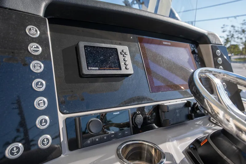 Slide: The Image of 2022 Robalo R242 boat dashboard with Yamaha and Simrad displays, steering wheel, and control buttons. - 15