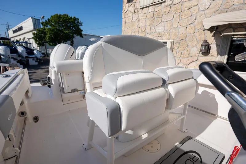 Slide: The Image of 2022 Robalo R242 boat interior with white seating and modern design. - 17