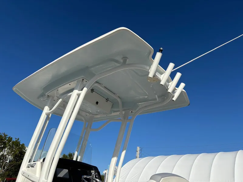 Slide: The Image of 2022 Robalo R242 boat T-top against clear blue sky. - 18